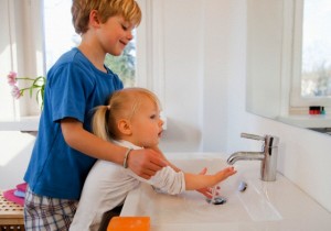 Brother and sister washing their hands