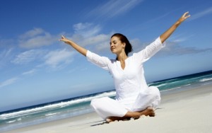 Woman meditating at beach