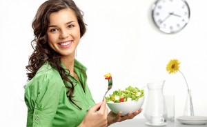 Portrait of a girl looking positive and holding a bawl with salad