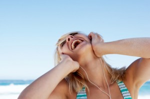 Young blonde female listening intently to music on headphones